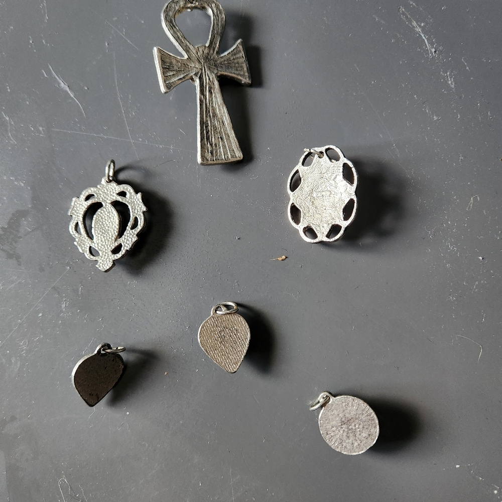 6 silver pendants with turquoise colored stones